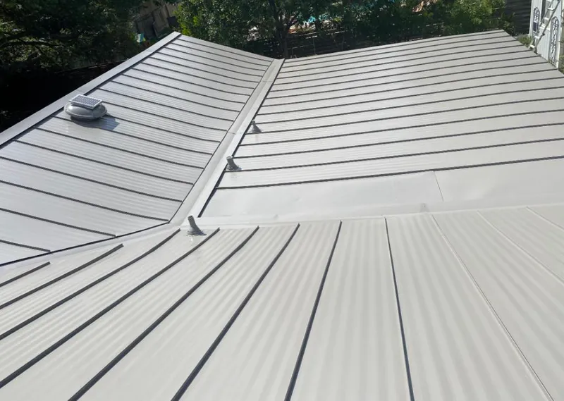 Solar attic fan installed on a metal roof for Roof Ventilation in Brownville